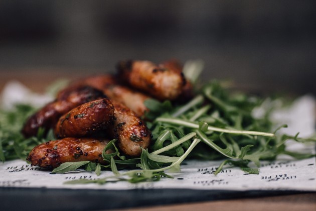 Pieminister chipolatas on a bed of rocket leaves