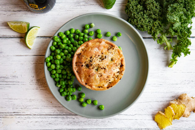 Evergreen Pieminister pie on a plate with peas